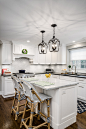 Example of a mid-sized transitional l-shaped brown floor and dark wood floor eat-in kitchen design in Philadelphia with an undermount sink, shaker cabinets, white cabinets, quartz countertops, white backsplash, porcelain backsplash, stainless steel applia