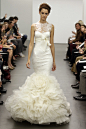Vera Wang Bridal Fall 2013——Look 11: Stretch mikado mermaid gown with floating tulip and rose lace overlay accented by table pleated organza rosette skirt. 