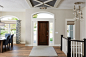 Example of a large classic light wood floor and brown floor entryway design in Minneapolis with gray walls and a dark wood front door