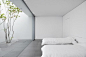 Bedroom with a view to a small patio. the Minimalist House by Shinichi Ogawa. Photo by Jonathan Savoie  Architecture.
