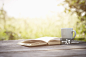 Book and cup on garden table.