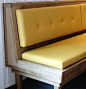 Wraparound bench with padded sides and lots of throw pillows