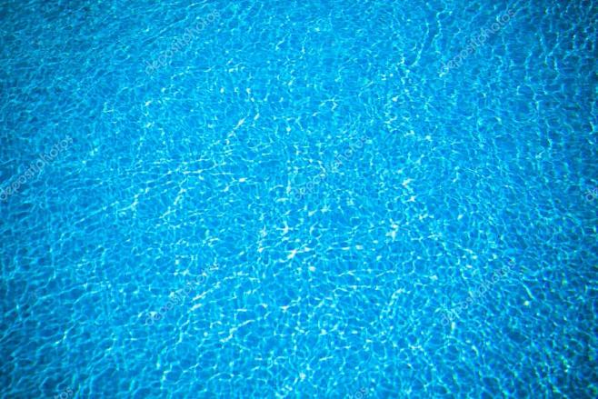 清除透明游泳池水背景。太阳在游泳池的水从...