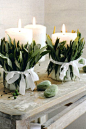 Fresh leaves tied with ribbon around candles