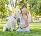 Pet dog licking face of Caucasian girl on grassy lawn by Gable Denims on 500px