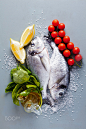 Fresh uncooked dorado or sea bream fish with lemon, herbs, oil, by irina grigorii on 500px