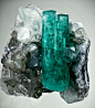 Vivid green Emerald on sparkly Calcite matrix. Next to it is a twinned Calcite. From Coscuez Mine, Boyaca Dept., Colombia