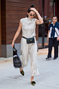 Kendall's slinky, silvery two-piece set was broken up by her Chanel waist bag.