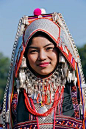 Myanmar, Burma, Kengtung. An Akha woman wearing traditional costume with a headdress of silver and beads.  © John Warburton Lee.