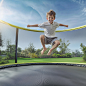 loviotech_A_boy_is_jumping_on_the_trampoline_The_background_is__ea32404e-0e51-4360-aab4-ddd8ca17c61f
