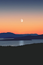 silhouette of mountains next to body of water