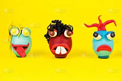 复活节彩蛋卡通人物与橡皮泥的眼睛，嘴和头发有一个富有表情的脸