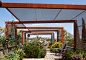A rooftop garden uses steel armatures with perforated metal panels to provide relief from the sun.