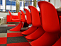 The board room is filled with these funky red chairs.