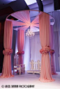A simply stunning fabric mandap! Floral cuffs and dropped chandelier for the WOW factor!