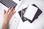 工作，办公-Woman working on laptop with notebook and mobile phone on table