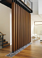 Wood SCREEN wall with stones #wood #architecture | Found on Pinterest via Patricia Gray