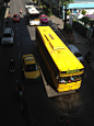 yellow bus beside taxi on the road