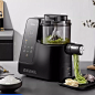 a black blender sitting on top of a table next to a bowl of food