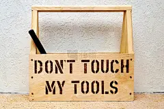 木制工具箱，用于家庭维修和维护。单独的文本框-不要碰我的工具，和一个锤子里面