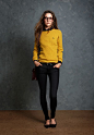 Bright yellow cable knit sweater over black button-up shirt, black skinny jeans, black ballet flats, black belt