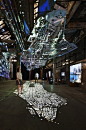 glowing 50ft map of New York's subway system hangs from a dark ceiling and projects different measurements of time, space & travel upon the ground below / Columbia University Graduate School of Architecture