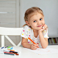 Smiley girl at home drawing