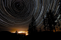 Star Trails Over Oregon   As the Earth spins on its axis, the sky seems to rotate around us. This motion, called diurnal motion, produces the beautiful concentric trails traced by stars during time exposures. Partial-circle star trails are pictured above 