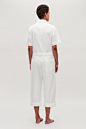 Model side image of Cos belted cotton jumpsuit in neutral