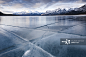 Cracked ice on frozen glacial lake, Abraham Lake, Canadian Rockies, Alberta, Canada