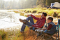 Father and son on a camping trip fishing by a lake - Stock Photo - Dissolve