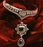 channel set diamonds with a princess cut emerald center, baguette diamonds and a gorgeous emerald droplet