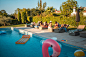 Diverse Friends Enjoying Pool Floats by the Water stock photo