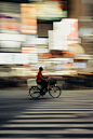A blurry photo of a person riding a bike