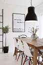 Pops of Black - like farm table with the white Eames chairs and black pendant light