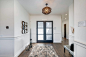 Entryway - mid-sized transitional medium tone wood floor and brown floor entryway idea in Boise with white walls and a glass front door