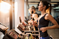 People running on a treadmill in health club.