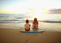 Photograph Caucasian children sitting on surfboard on tropical beach by Gable Denims on 500px