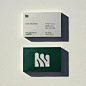 This may contain: two business cards sitting side by side on top of a white surface with green lettering