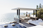 Waiter serving woman drinks at cabana overlooking ocean by Caia Images on 500px