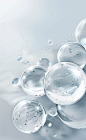 A white background with several glass spheres of different sizes floating in the center, arranged in an oval shape. The spheres have clear water inside and some bubbles on their surface. There is space around them for text or other elements to be added la