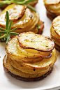 Three potato stacks stacked up together on a plate.