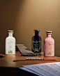 Three bottles of fragrances from the Alchemist’s Garden range stand on the base of a guitar. From left to right the Where My Heart Beats fragrance in a white bottle, in the center the A Midnight Stroll fragrance in a black bottle, and on the right the A C