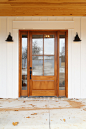 Entryway - mid-sized cottage concrete floor entryway idea in Other with white walls and a medium wood front door