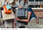 two girls with shopping bags in front of show-window with sale written on it, close up