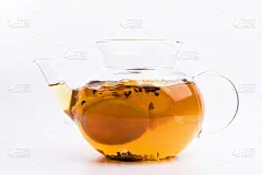 玻璃茶壶与绿茶和新鲜的橙子孤立在白色的背景