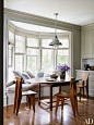 The breakfast area of Edie Parker accessories designer Brett Heyman's Connecticut home is filled with natural light, adding to its inviting and cozy atmosphere. | archdigest.com