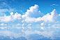 clouds and reflection in the water, in the style of realistic rendering, high horizon lines, ethereal cloudscapes, joyful and optimistic, light white and light indigo, rendered in maya