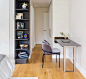 A modern bedroom with a desk that folds up and slides into the wall.