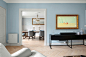 A living room filled with furniture and a painting on the wall